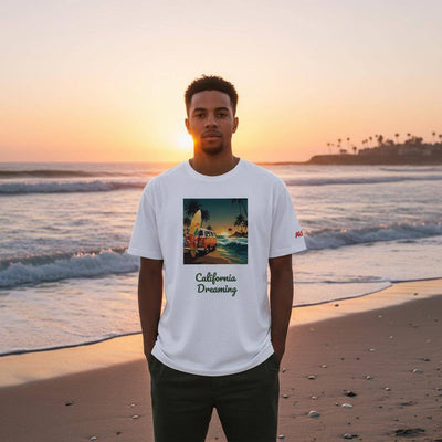 a man on a beach wearing an organic tee by AUNTI with front design of a van with surfing boards