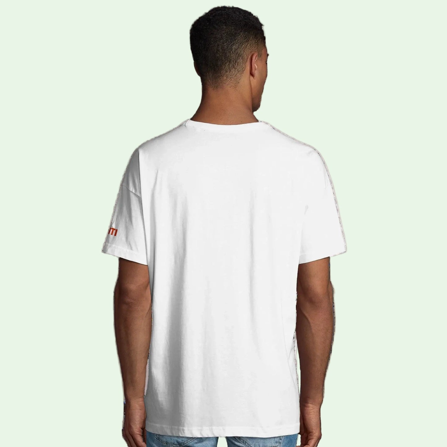 Man wearing organic cotton in conversion white tee, back view.