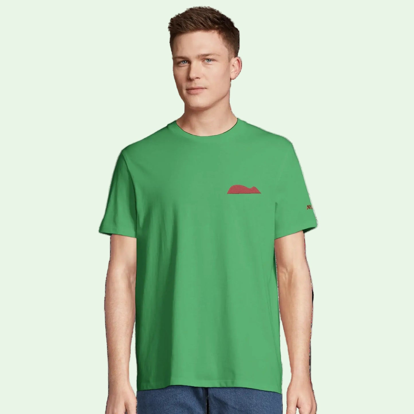 young man wearing a green organic cotton tee with mouse of getaria embrodery in garnet