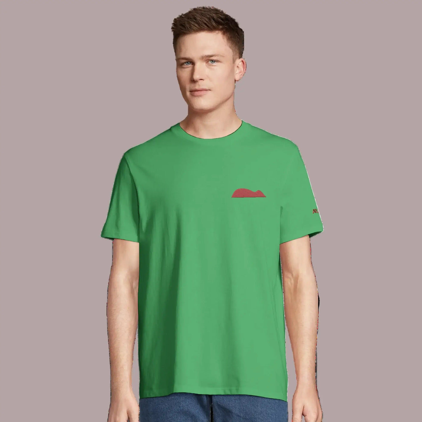 young man wearing a green organic cotton tee with mouse of getaria embrodery in garnet