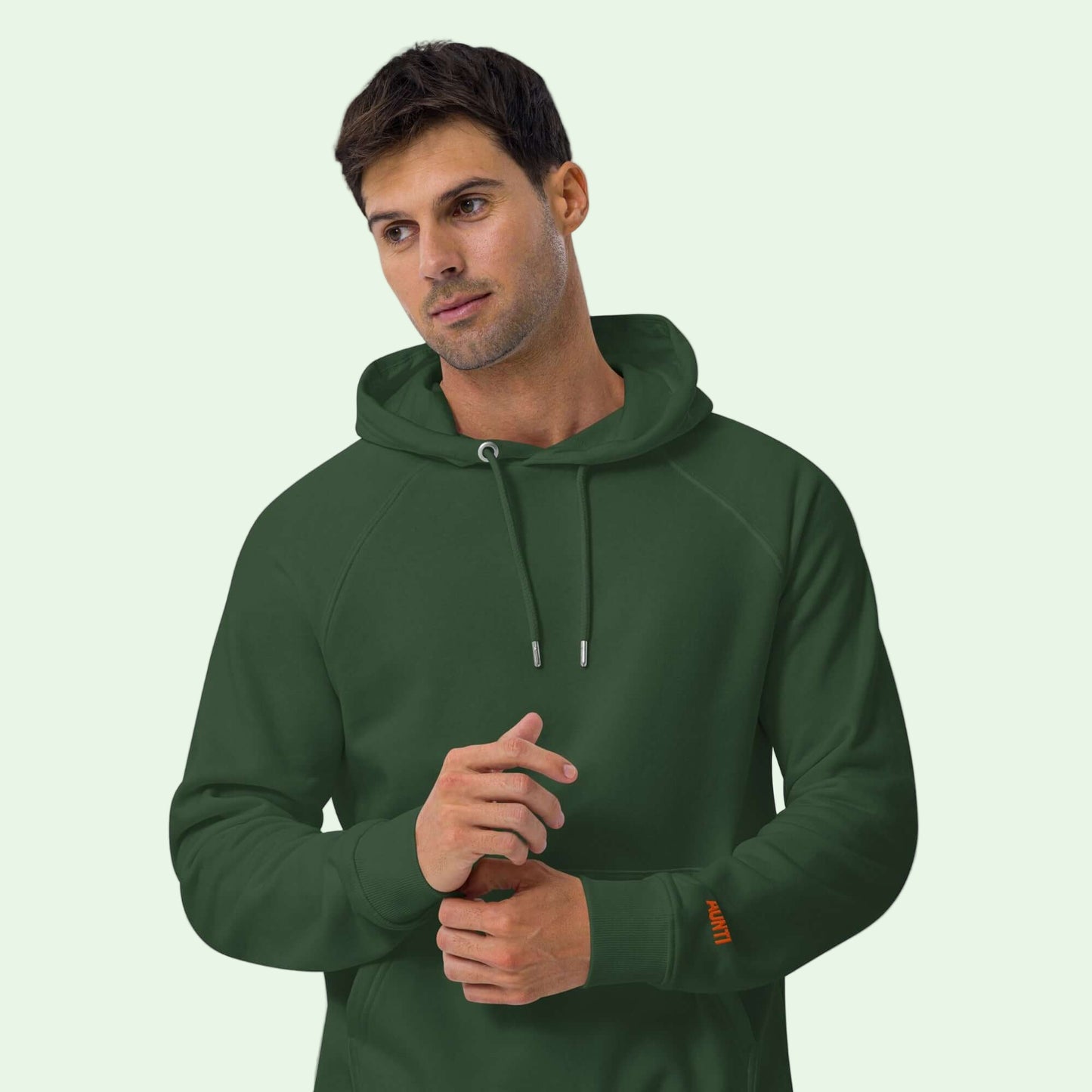 a man wearing an unisex eco ranglan hoodie bottle green by aunti front view