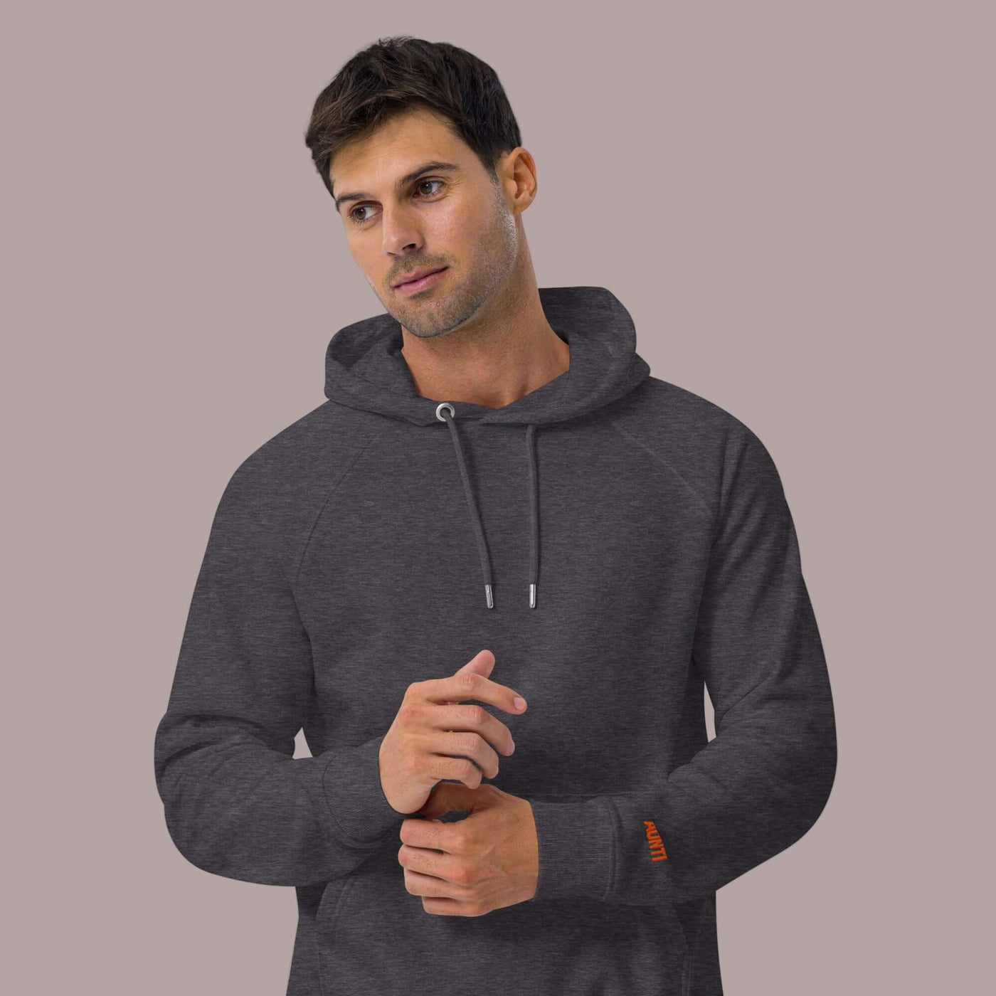 man wearing a sustainable grey hoodie with left sleeve embrodery AUNTI