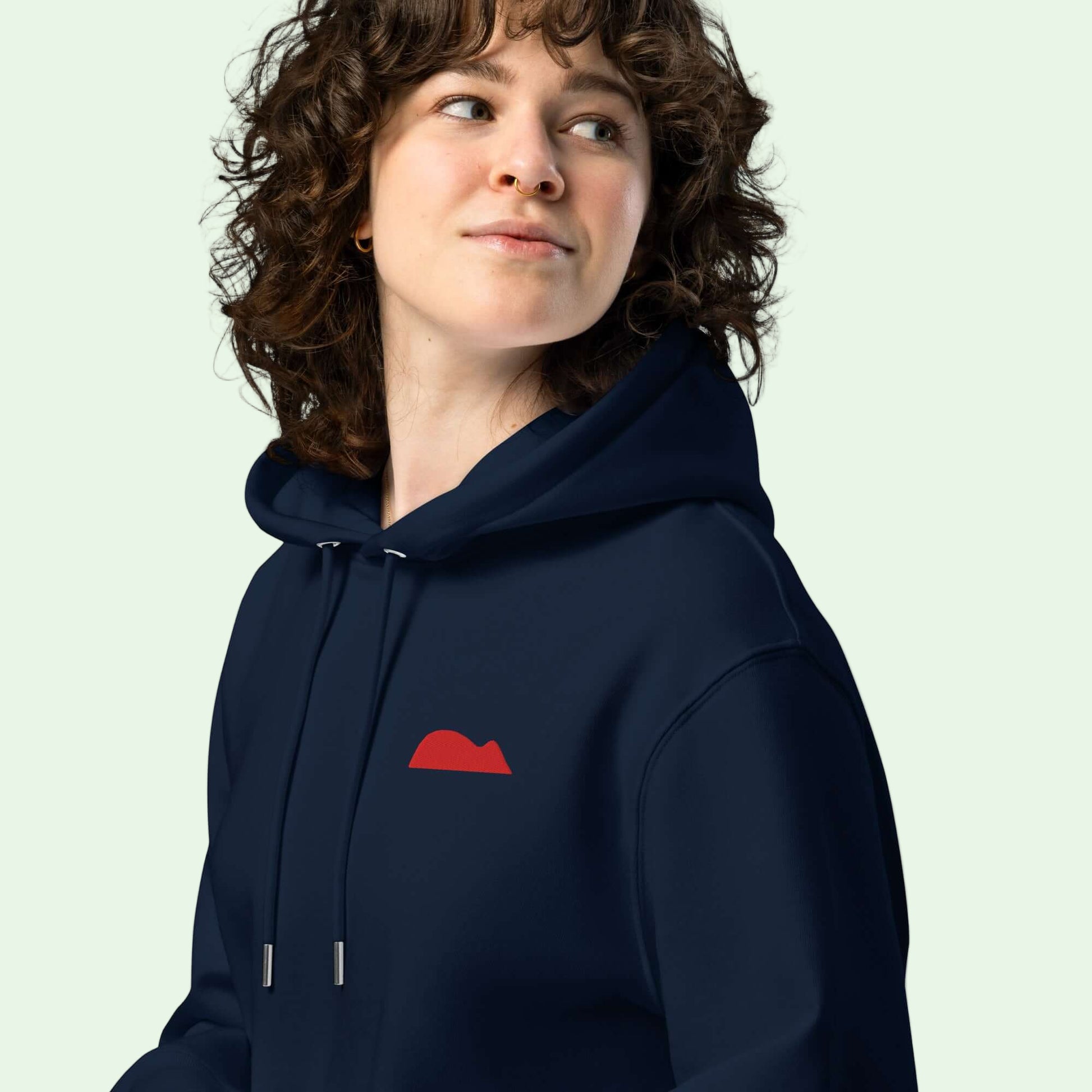 woman wearing an unisex eco hoodie french navy with Getaria Mouse embroided in red by Aunti