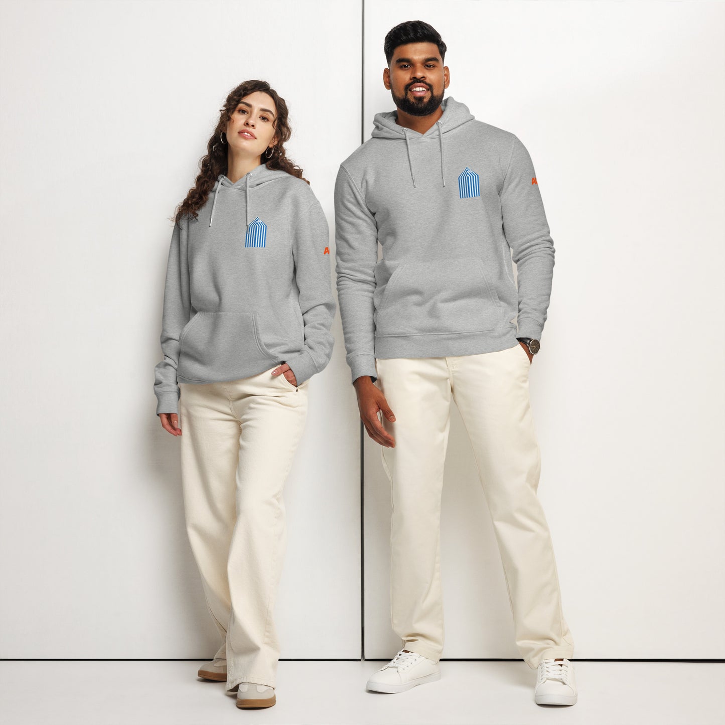 couple wearing an unisex organic hoodie with beach cabins design on front and back by Aunti