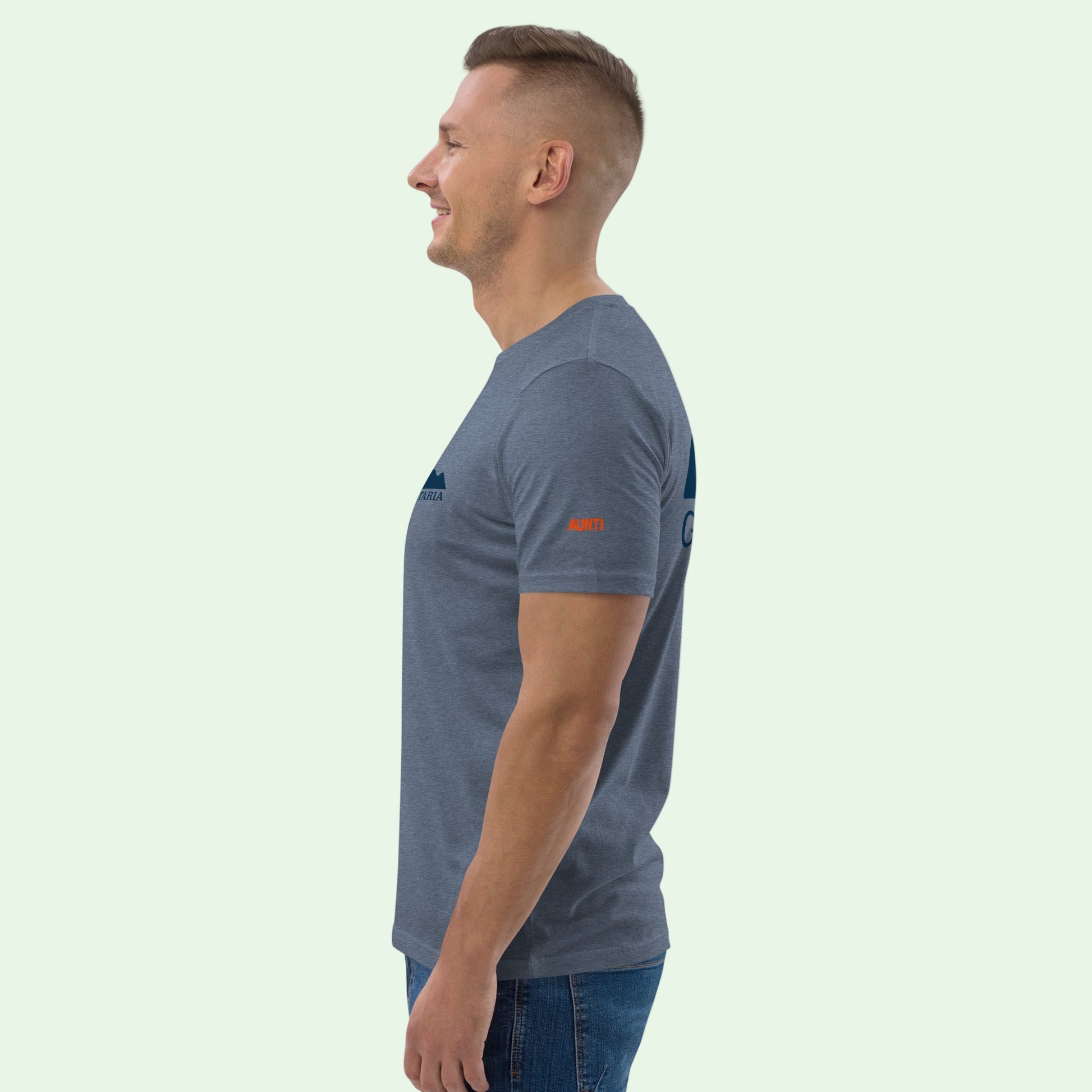 man wearing an unisex organic cotton t-shirt in dark blue heather with Aunti embrodery in orange on left sleeve. Left view. 