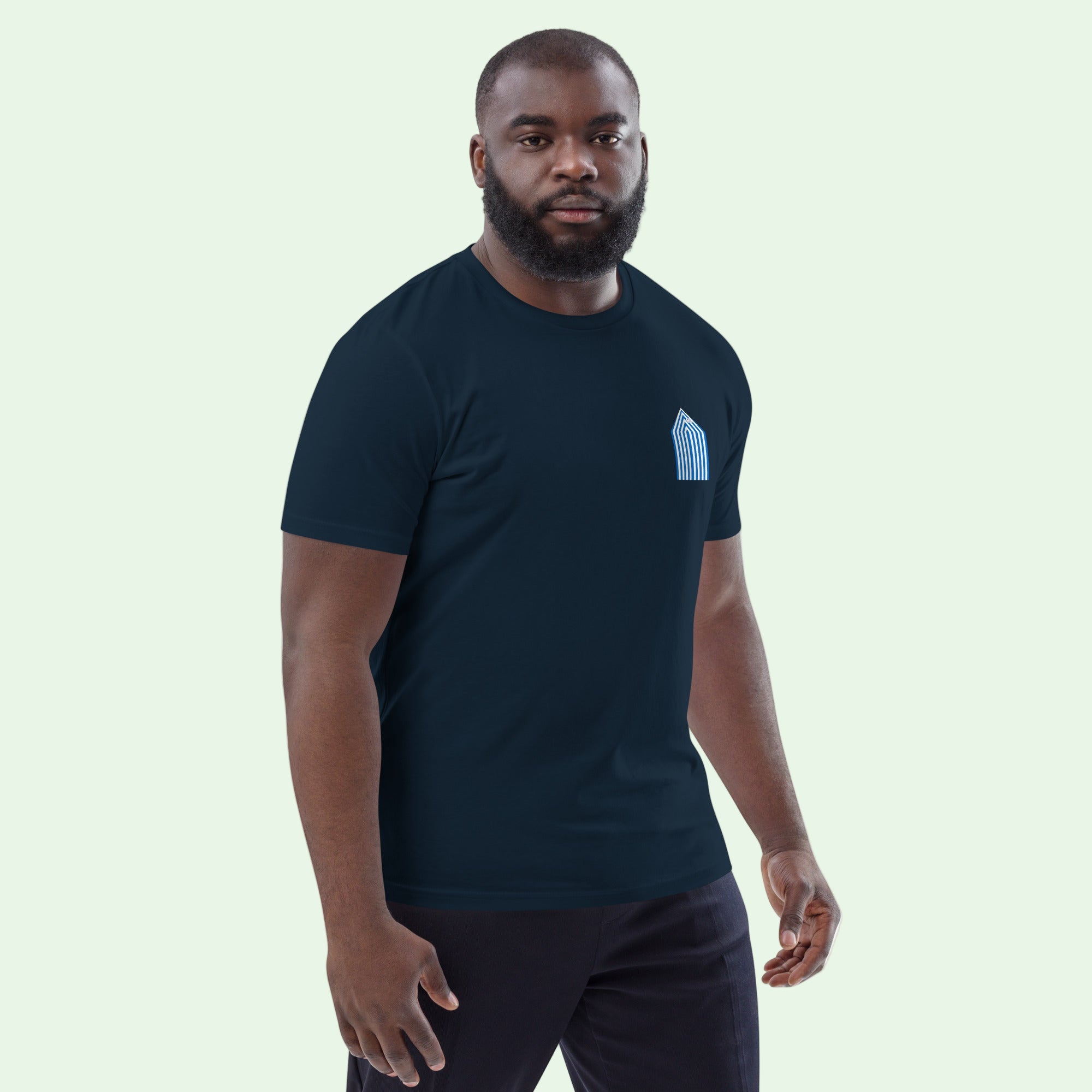 man wearing an organic cotton gots certified t-shirt in navy with beach cabins design by Aunti