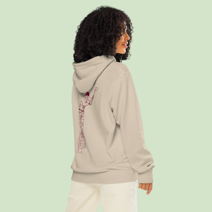 a woman wearing an unisex organic mid-weight hoodie in desert dust with a back aizkolari desgn by Aunti