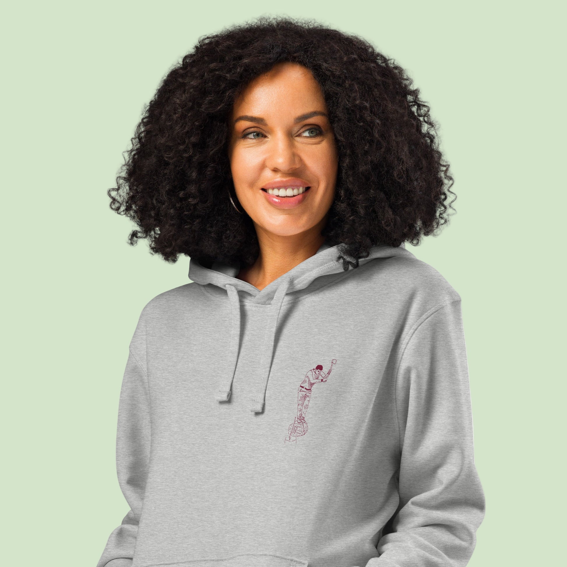woman wearing a heather unisex organic mid-weight hoodie with aizkolari front design by Aunti